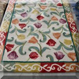R34. Company C rug with tulips design.